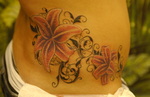 Tribal-Tattoo mit Blüten bei der Frau auf der rechten Taille - gestochen von Sara Klemp, Skinfactory Tattoo und Piercing, Bonn